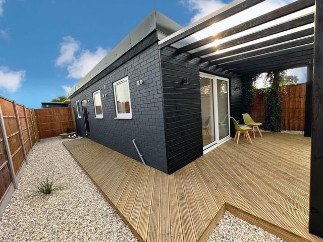 An outdoor area with decking and chairs at a luxurious guest house in Yorkshire with parking Hemingbrough, Yorkshire