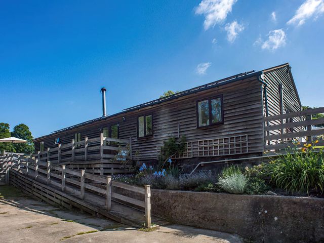 A barn with wooden decking and handrails at Accessible 4-Bed Barn, Sleeps 8 - Farm Stay near Mayfield