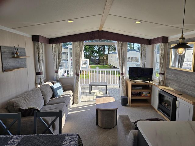A living room with a sofa and television at 3 Bed-Sleeps 8-Free Parking-5 Min to Beach Embo near Dornoch