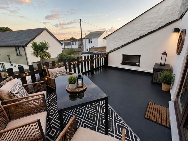 An outdoor terrace with seating and a table at Stylish Cornish Retreat, Sleeps 4 Near Hayle Beach in Hayle
