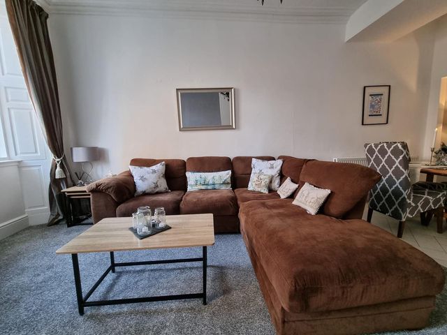 A living room with a brown sofa and coffee table at Rose Apartment 2-Bed Apt, Sleeps 4 Town Centre Ayr