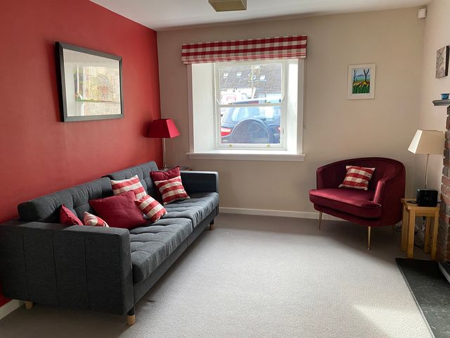 A living room with a sofa and armchair at Charming Cottage in North Berwick