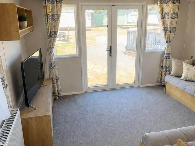 A living room with a TV and sofa at Billing Aquadrome Holiday Park - 2 Bedroom, Silver, Northampton
