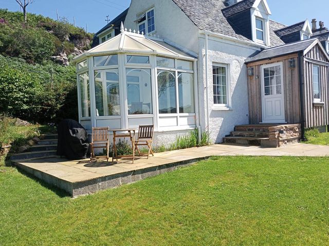 An outdoor patio with a table and chairs at Marsco Apartment Garden Patio Sea Views in Applecross near Lochcarron