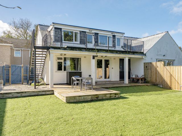 An outdoor area with a deck and seating at 2 Bedroom Apartment Sleeps 3 Garden Pets Carbis Bay