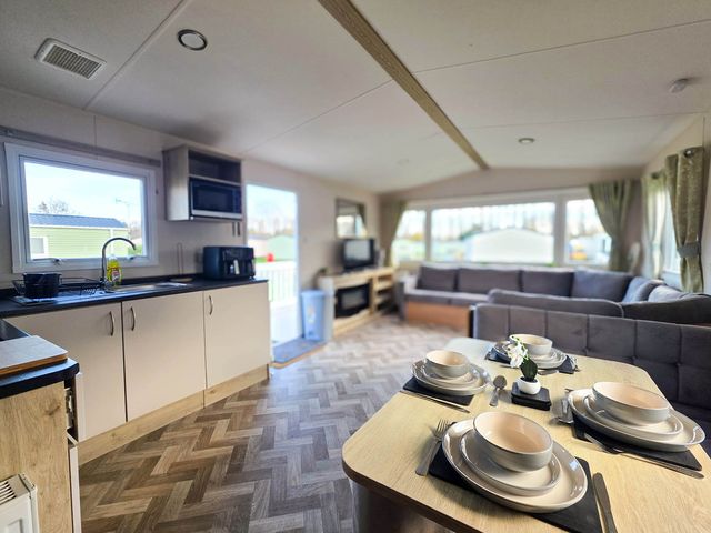 A kitchen with a living area and dining table at Static Caravan 3 Bed Sleeps 8 Dog Friendly Parking Northampton