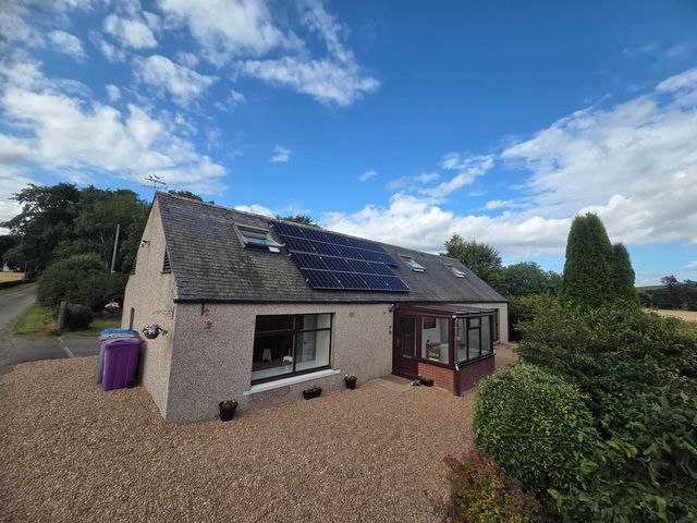 A house with solar panels and a conservatory at Farm Cottage at foot Angus Glens Kirkton of Kingoldrum near Kirriemuir