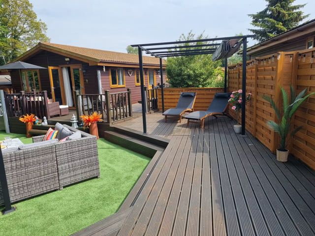 A garden with lounge chairs and outdoor seating at Cabin Sleeps 4 with Hot Tub and Parking near Wilberfoss