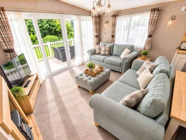 A living room with sofas and a coffee table at Cala Gran 3Bed Caravan Sleeps 8 Wrap Decking, Fleetwood