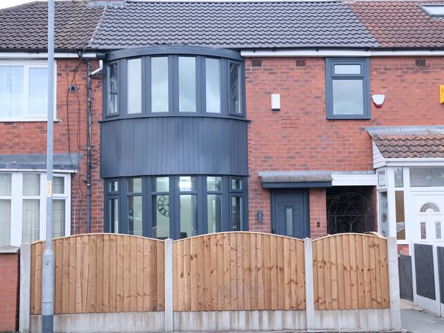A house with a curved window and wooden fence at 3 Bedroom, Modern House in Manchester