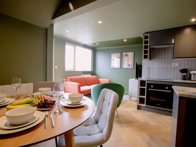 A dining area with a table set for a meal at 1 Bedroom Apartment, sleeping 3 with balcony and pet friendly, Carbis Bay