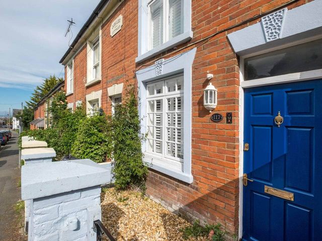 An exterior view of a house with a blue door and window at Impeccable 3 bed 2 bath Central Cowes Cottage Cowes