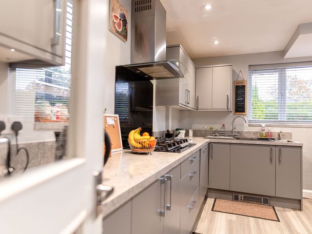 A kitchen with a stove and sink at 3 Bedroom, sleeping 5 with Wifi, Wythenshawe near Manchester