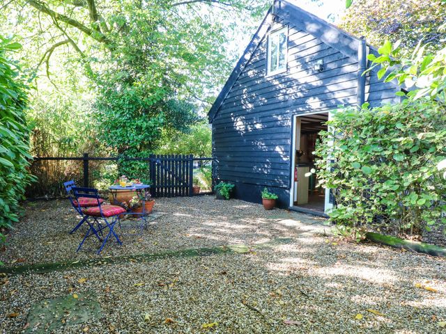 A garden with chairs and a table at Corner Barn North Burlingham near Blofield