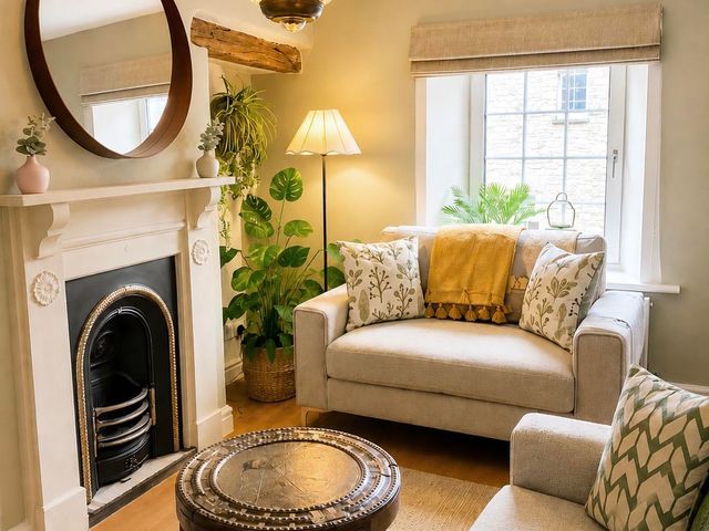 A living room with a sofa and coffee table at Muddy Boots – Arcade Royale in Kirby Stephen