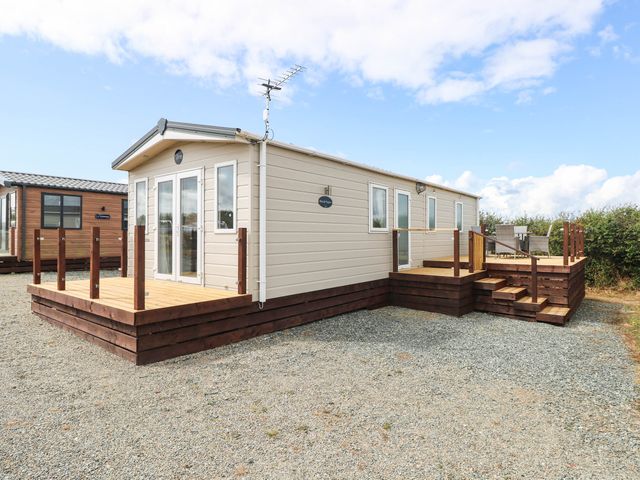 A house with a deck and steps at Seascape in Haverfordwest