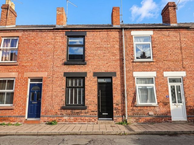 A row of brick houses with doors and windows at 9 North Street Chester