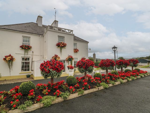 An outdoor area with a building and flower arrangements at Bruckless Rest Fine Country Dining B&B Bruckless