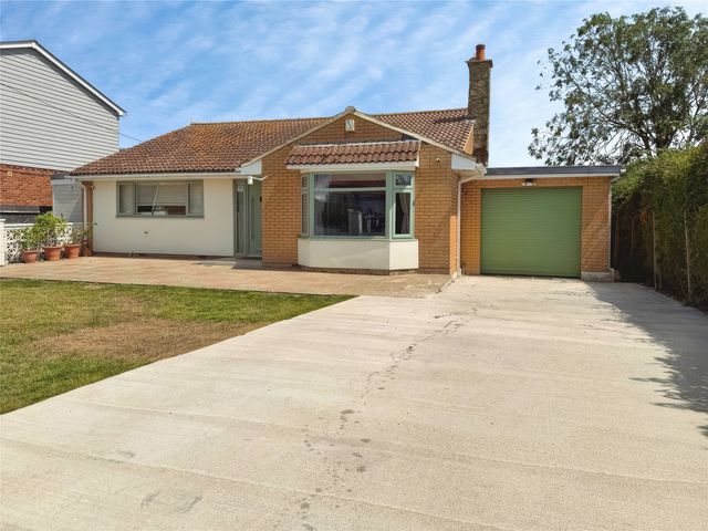 A house with a garage and driveway at Gralyn Place