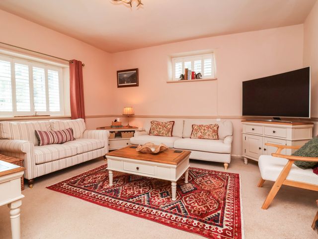 A living room with a sofa and coffee table at Myrtle Cottage in Lynmouth