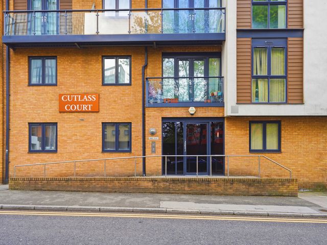 An apartment building with the sign Cutlass Court in Birmingham