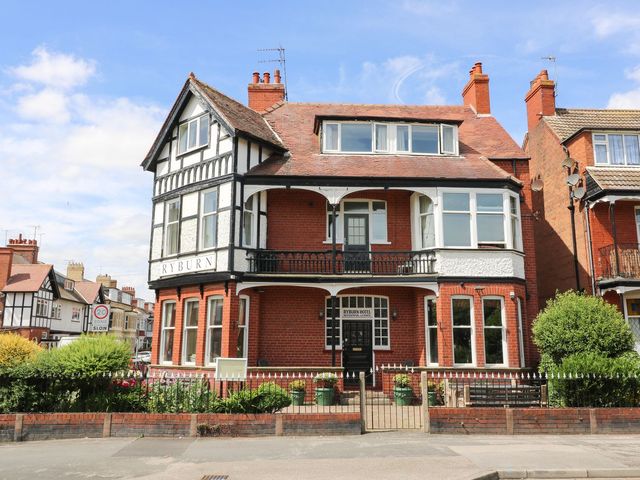 A house with a balcony and sign at Ryburn Lodge in Bridlington