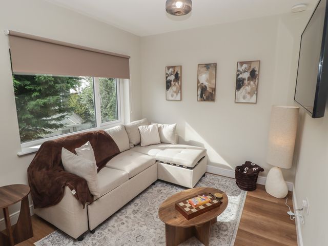 A living room with a corner sofa and coffee table at Flat 4 in Tenby
