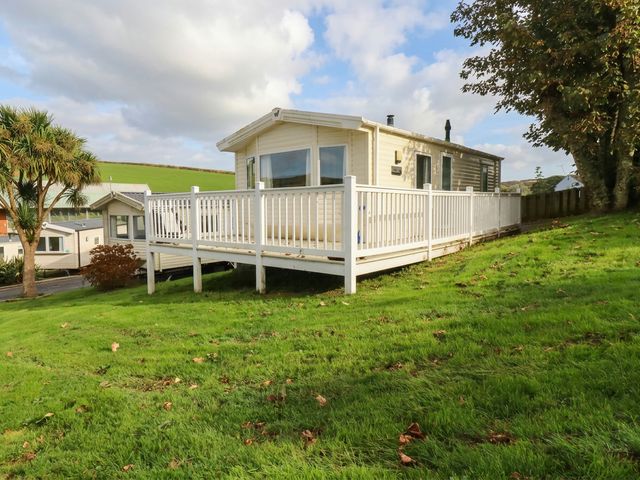 A house with a deck and lawn at Number 14, Newquay Bay Resort