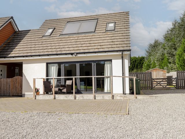 A house with a patio and gravel area at Broomfield Hideaway near Inverness