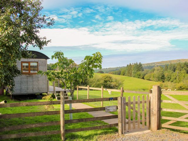 A shed near a wooden gate in a field at Hideaway Hut at Hopton Court Estate Hopton Wafers near Cleobury Mortimer