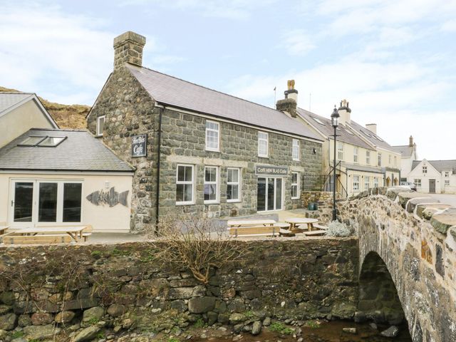 A cafe with stone exterior and bridge in Pwllheli