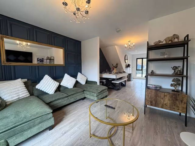 A living room with a sofa and coffee table at 11 Radclyffe Mews in Salford