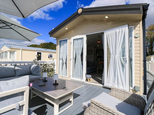 An outdoor seating area with furniture and an umbrella at 216 Solent Breezes Southampton