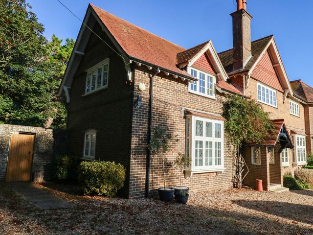 Side view of a house with windows and plants at Osmington Cottage Annex