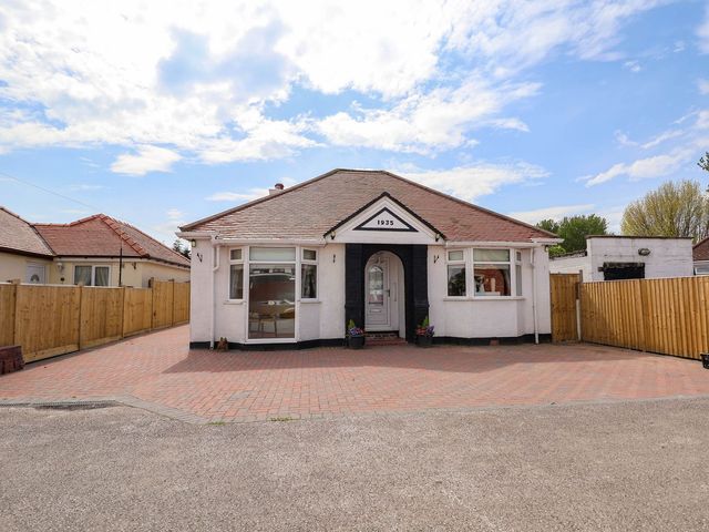 A house with a driveway and fence at Brimrod Talacre