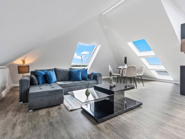 A living room with a sofa and coffee table at Flat 6, Hilltop Court Uxbridge