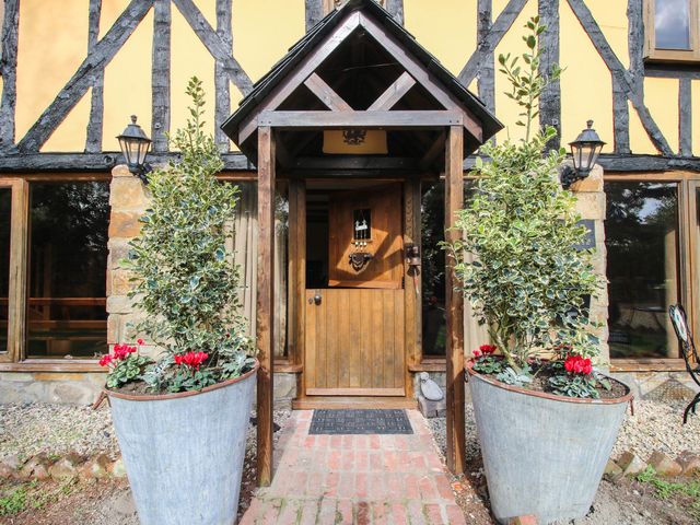 An entrance with plants and a wooden door at The Duck House at Hyssington Farm near Montgomery