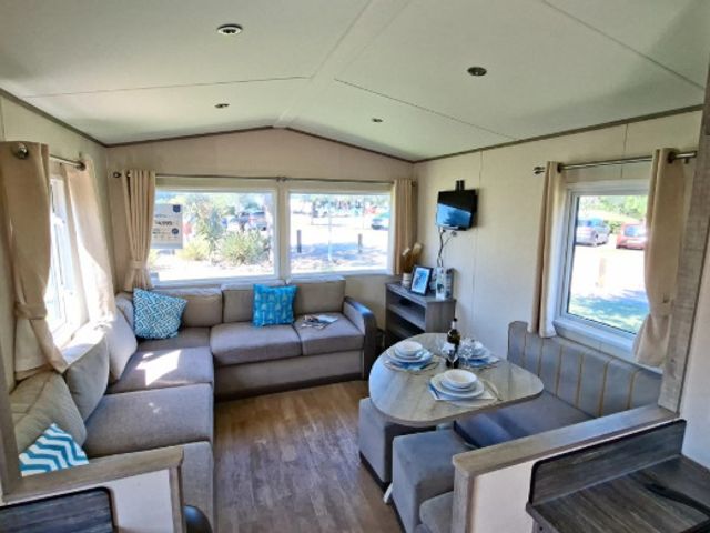 A living room with a sofa and television at Haven Golden Sands Abi Marina in Mablethorpe