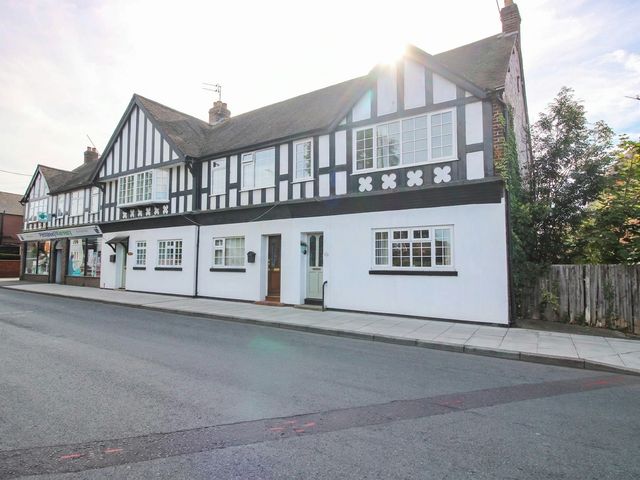 A building with multiple windows and a door at 3 Jubilee Cottages Pontesbury