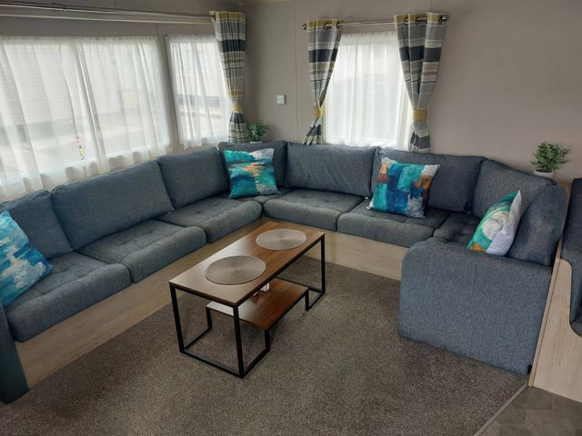 A living room with sofas and a coffee table at St Osyth Beach in St. Osyth