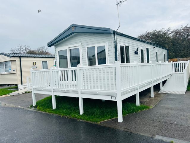 A mobile home with a deck and railing at Cala Gran - The Retreat 256 Boundary Road Fleetwood