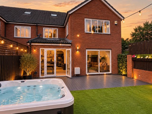 An outdoor area with a hot tub and sliding glass doors at 20A Westend Parade, Gloucester
