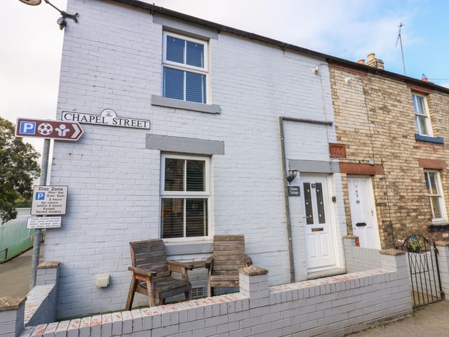 A building exterior with a door and window at Crown Cottage in Appleby-In-Westmorland