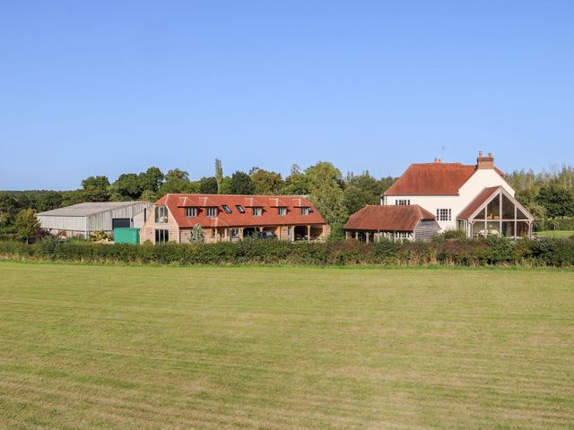 A house and barn surrounded by a field at The Granary 2 Bed in Bordon