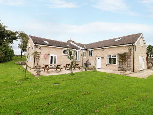 A house with a garden and seating area at Greystones - Apartment B near Buxton