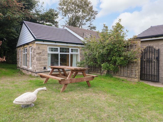 A picnic table in a garden at Greystones - Apartment E near Buxton