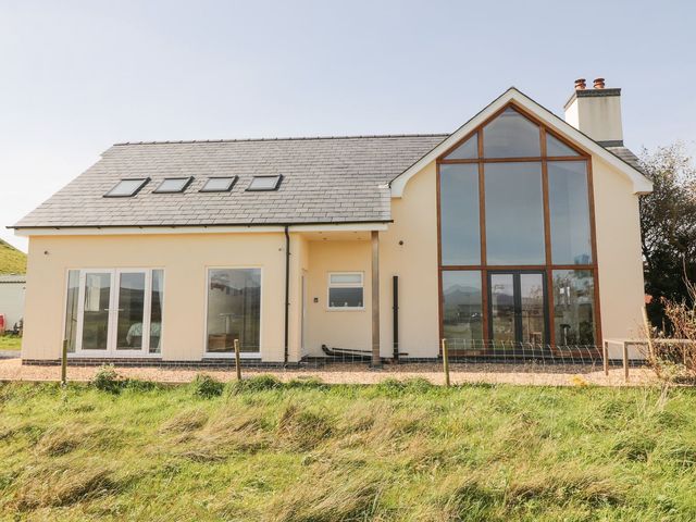 A house with large windows and a fence at Cae Mawr in Caernarfon