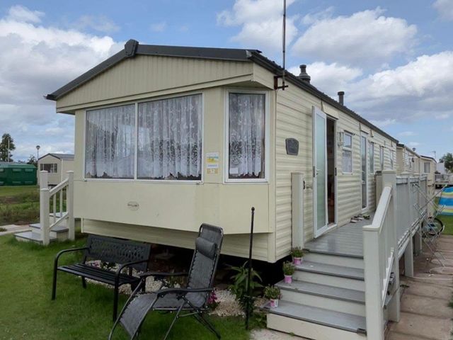 A caravan with steps and a bench at Golden Sands Haven, Sunflower Haven, Mablethorpe
