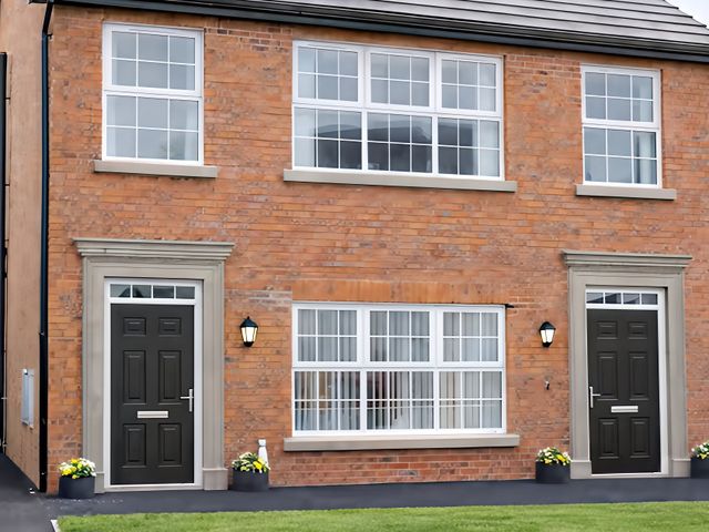 An exterior view of a house with two entrances at Long Meadow Apartment in Portglenone