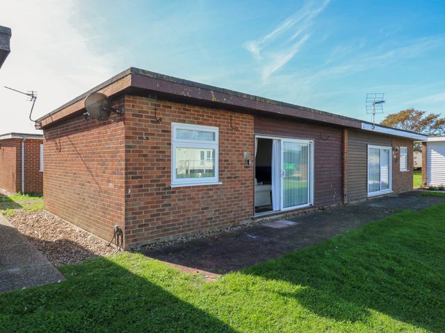 An outdoor view of a building with windows and grass at 110 Bay View in New Romney